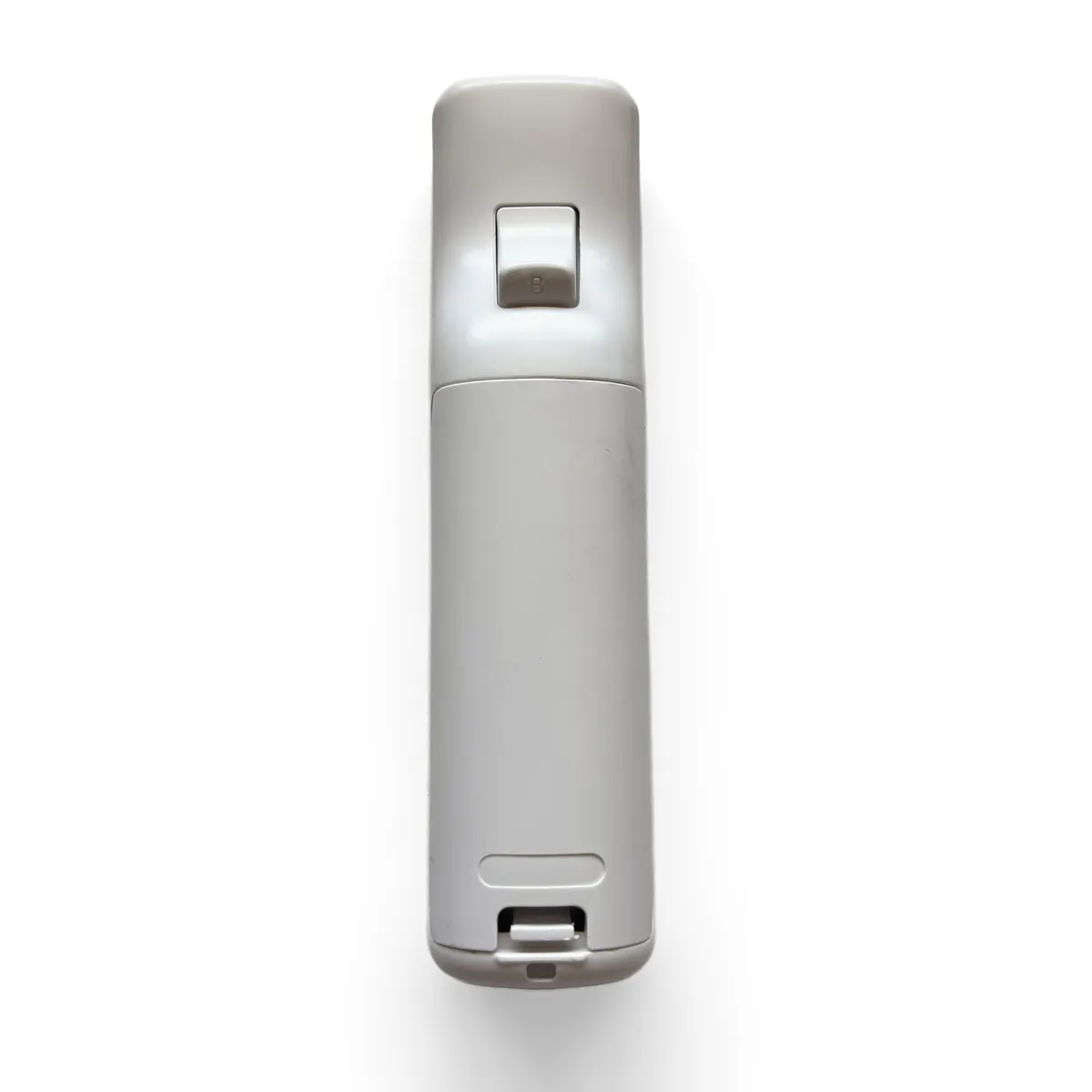 Thumb pressing the tab on the battery cover to slide it off