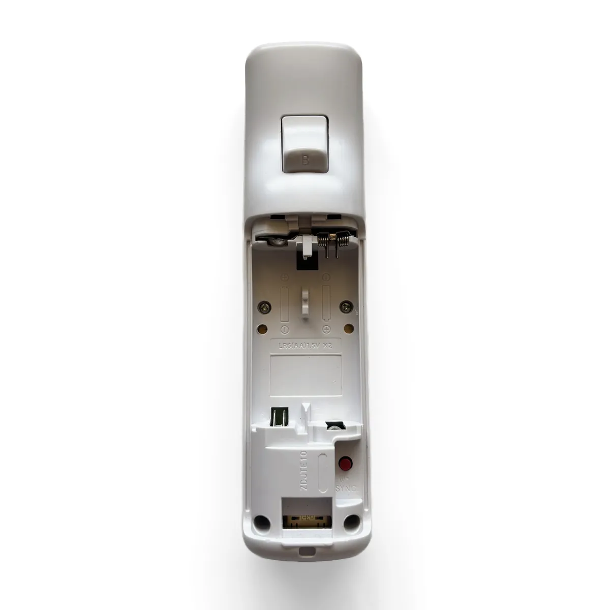 Open battery bay with the four tri-wing screws circled in red, two at the top and two at the bottom