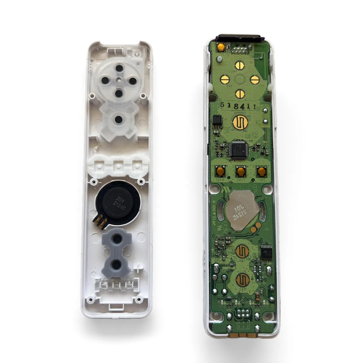 Top shell lifted away and set face down beside the bottom shell with the original board still seated