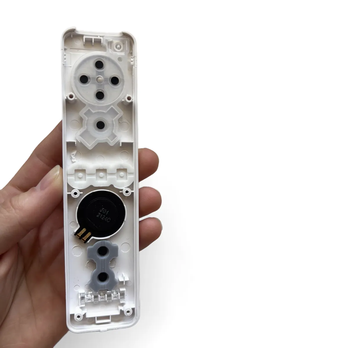 Inside of the empty top shell showing the rubber button membranes and the speaker