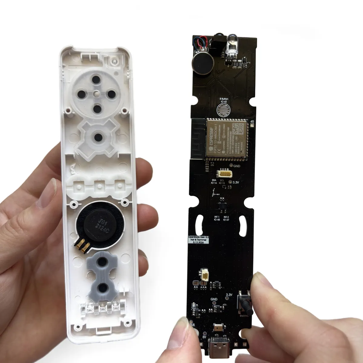 OpenMote board being lowered into the top shell, USB-C port at the bottom end