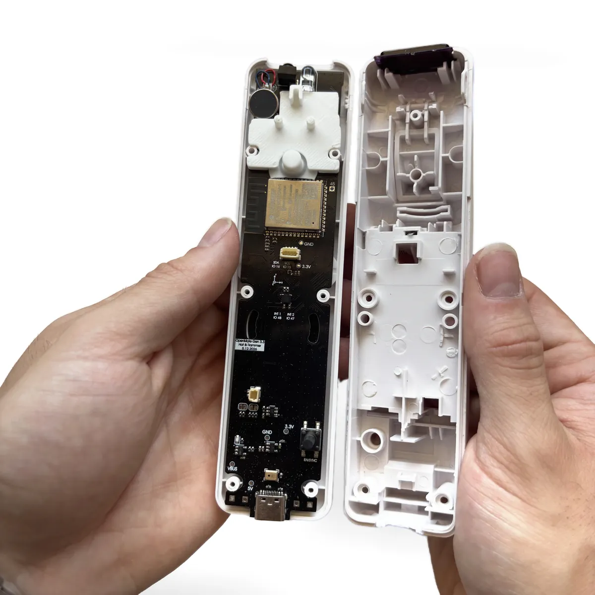 Bottom shell lowered onto the top shell with the reset button hole circled in yellow and a line to the reset button on the board