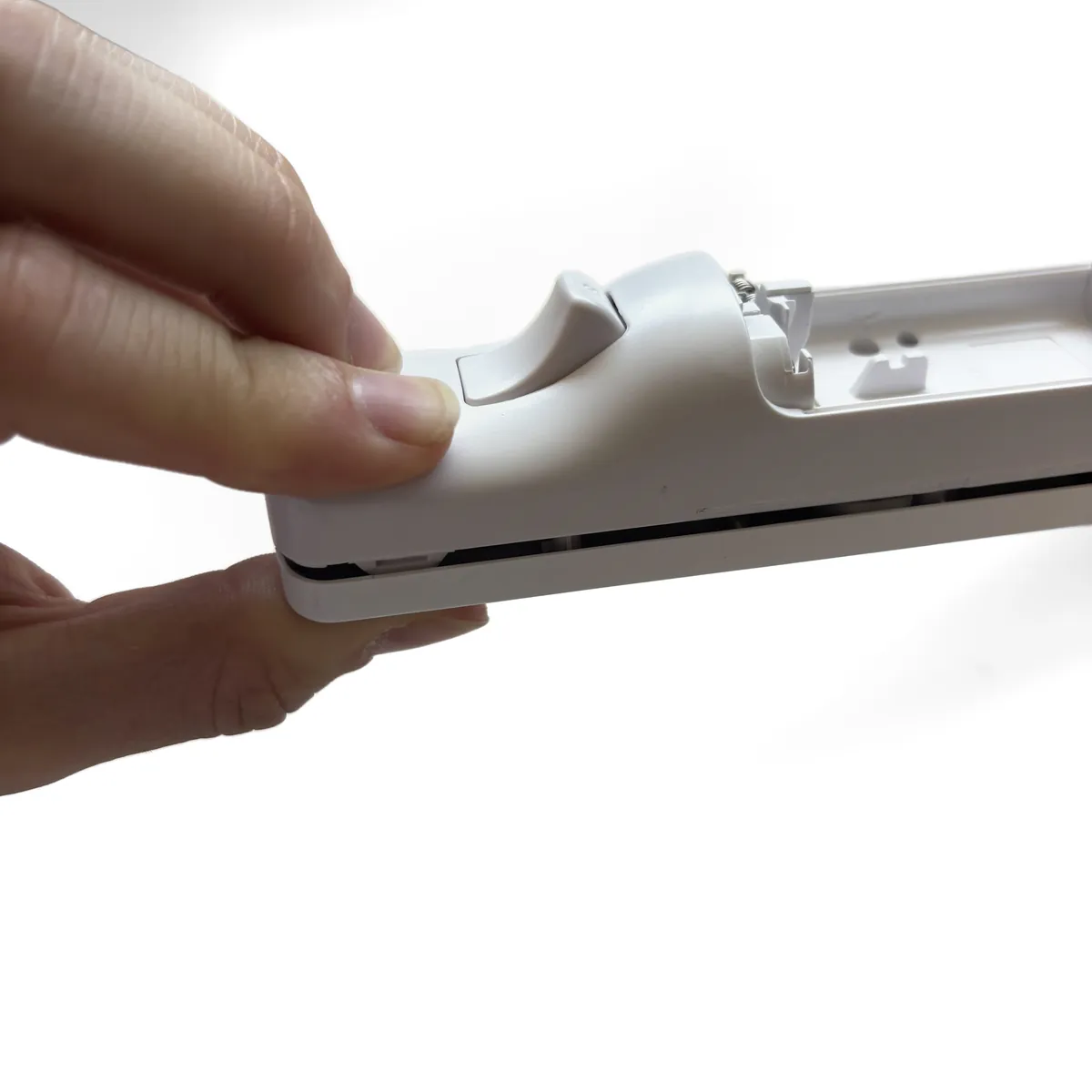 Thumbs squeezing the shells shut at the top end, one clip at a time