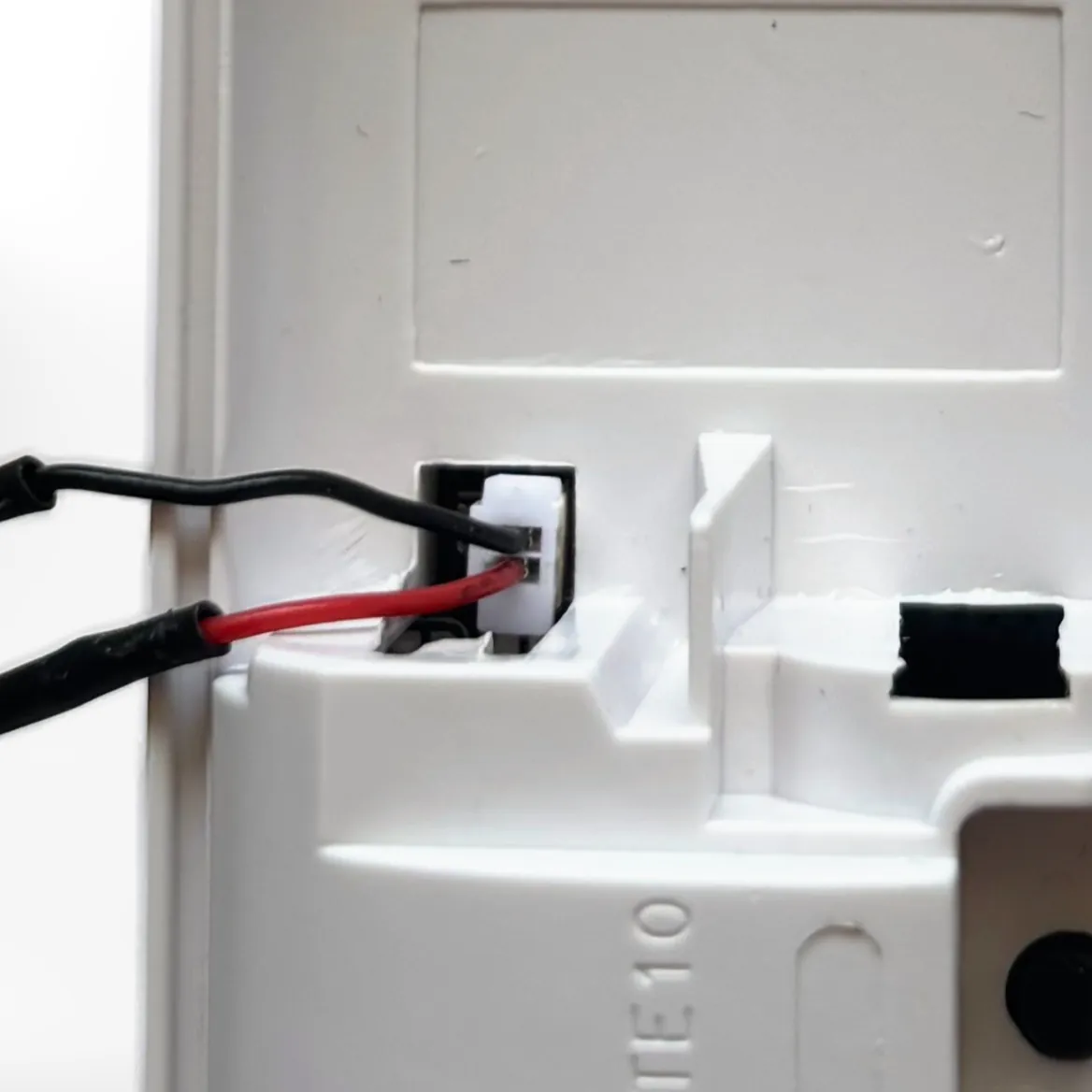 Close-up of the battery socket. The black negative wire goes in the top pin, marked Negative, and the red positive wire in the bottom pin, marked Positive
